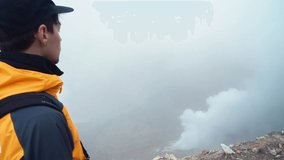 Hiker man posing on top of a sulfur volcano Hikers with backpacks relaxing on top of a hill and enjoying view. Kamchatka Russia - Powered by Shutterstock - Get 15% off with code: PIKWIZARD15