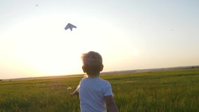 Kid with paper plane is run. Happy boy in park. Kid is holding paper plane. Happy boy dream of an airplane. Kid run through park. Airplane pilot boy. Chidhood dream. Happy boy with toy airplane - Powered by Shutterstock - Get 15% off with code: PIKWIZARD15