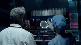 Doctors Interacting on Big Transparent Display Working with Patient Brain Scan Tomography Images and Neural System Data. Neurological Research Center. - Powered by Shutterstock - Get 15% off with code: PIKWIZARD15