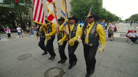 ORLANDO, FL circa November 2019 - Veterans Day Parade on the streets of Orlando. African American Buffalo Soldiers color guard marches in formation. Slow-motion.
