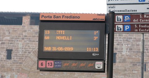 Florence, Italy - August 31, 2019: The Digital Display Of A Bus Stop Information In Firenze, Porta San Frediano Bus Stop, Italy, Europe. Close Up View Of Yellow LED Text - DCi 4K Resolution