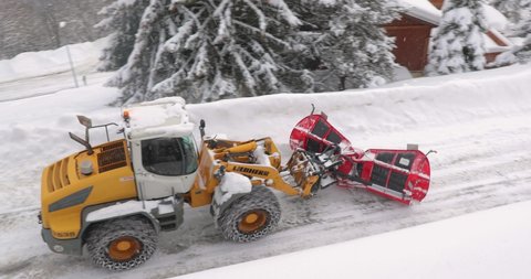 VALMOREL, FRANCE - JANUARY 31, 2019: Clearing snow from roads after heavy snowfall in the French Alps. Clearing the streets of the skiing village