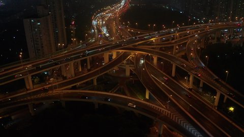 Rising shot shot the huge spectacular elevated highway and  roads, bridges, traffic in Shanghai at night, transportation and infrastructure development in urban China