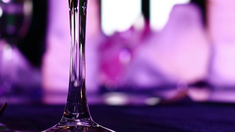 Left side frame of Glass of Wine, champagne, soft-drink and soda on Gala Dinner table with guests with moving light around. Gala Dinner and Party.