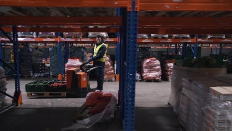 workers moves on a forklift in a warehouse