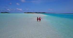 People holding hands and walking in the ocean on Vacation in Bahamas, relaxing landscape