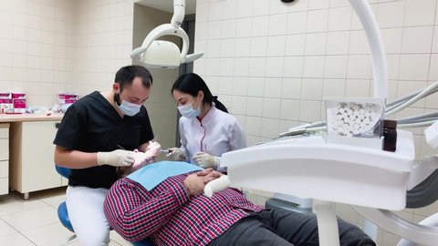 patient an appointment at the dentist and nurses. the treatment of the oral