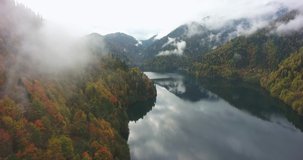 Beautiful mountain lake in a relic national park in the clouds. Aerial drone flight