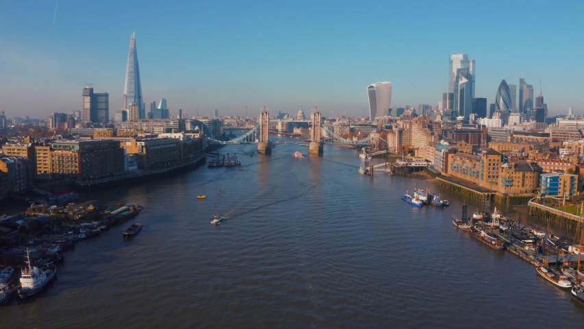 Beautiful aerial view of the Tower bridge in London, UK. Flying over the city with a magnificent London skyline view. Royalty-Free Stock Footage #1042617688