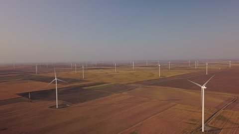 Aerial view of Wind turbines Energy Production in yellow fields