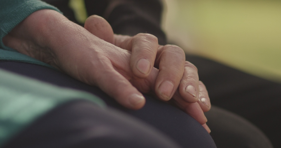 4K Faithful old couple holding hands. Close-up of hands of lovely aged couple caring and loving each other. Support trust in marriage relationship. Beautiful footage. Health care concept. Slow Motion. | Shutterstock HD Video #1042620355