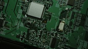 Green Printed Circuit Board, Computer Motherboard Components: Microchips, CPU Processor, Transistors, Semiconductors. Inside of Electronic Device, Parts of Supercomputer. Top View Moving Macro Shot - Powered by Shutterstock - Get 15% off with code: PIKWIZARD15