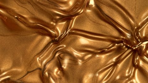 Super Slow Motion Shot of Golden Splashing Background at 1000fps.