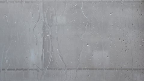 Water flow down on glass wall in bathroom shower, Nobody