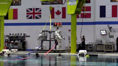 Houston , TX / United States - 02 22 2018: Astronauts Anne McClain (left) and David Saint-Jacques are lowered into the Neutral Buoyancy Laboratory for spacewalk (extravehicular activity) training