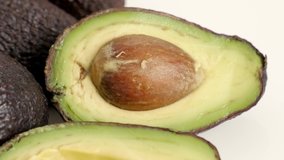 Exotic avocado (Persea americana) halves with seed 4K tilting video