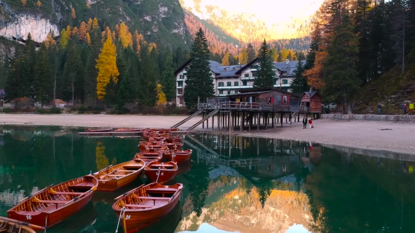 Boats on the Lago di Braies lake in Dolomites at sunrise, Italy
