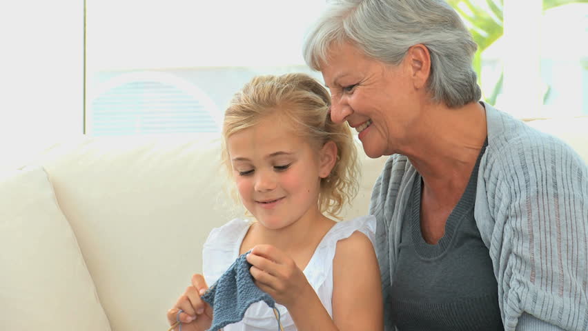 Grandmother teaching her grand daughter how to knit | Shutterstock HD Video #1042693