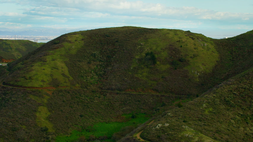 Flying over the Marin Headlands to discover the Golden Gate Bridge. San Francisco, US. This suspension bridge is one of the most iconic landmarks of California. Shot on Red weapon 8K.