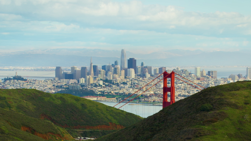 Flying over the Marin Headlands to discover the Golden Gate Bridge. San Francisco, US. This suspension bridge is one of the most iconic landmarks of California. Shot on Red weapon 8K.