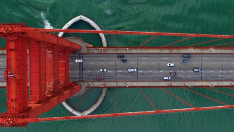 Traffic passing by the Golden Gate Bridge. San Francisco, US. Aerial view. It connects the San Francisco peninsula to Marin County. US route 101 and SR 1 full of cars. Shot on Red weapon 8K.