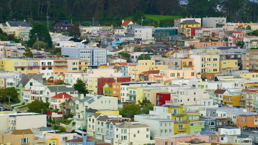 Aerial view of the magnificent Golden Gate Bridge with a cargo ship passing under it. This bridge connects the San Francisco peninsula to Marin County. US route 101 and SR 1 full of cars. Red 8K.
