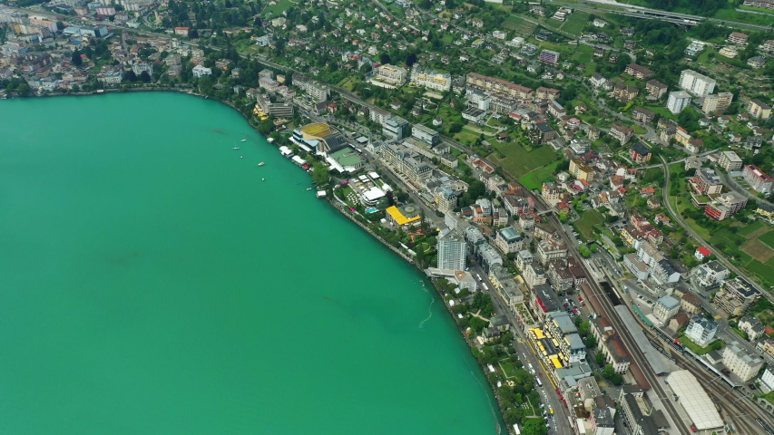 day time flight over montreux city geneva lake bay train station aerial topdown panorama 4k switzerland