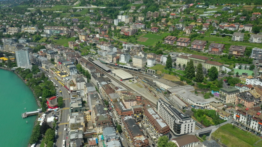 day time flight over montreux city geneva lake bay train station aerial panorama 4k switzerland