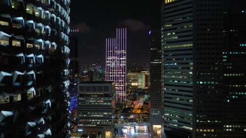 singapore city flight over night illuminated downtown aerial panorama 4k