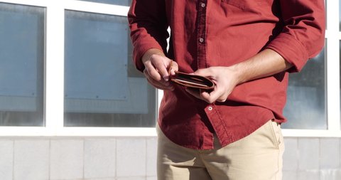 Man holding wallet with money outdoors, closeup