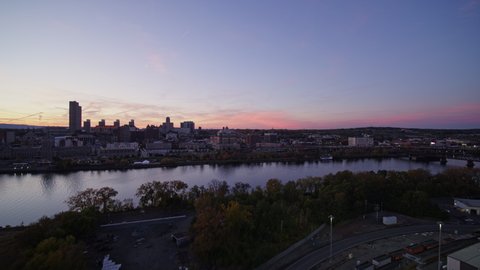 Albany New York Aerial Ascending panning view over Hudson River toward downtown cityscape view at dusk - October 2017