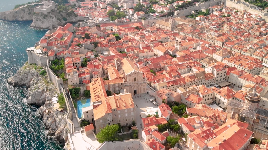 The aerial view of the famous fortified city of Dubrovnik with it's south wall and St. Lawrence Fortress | Shutterstock HD Video #1042727431