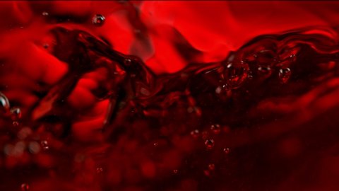 Super Slow Motion Macro Abstract Shot of Swirling Red Wine in Glass at 1000fps.
