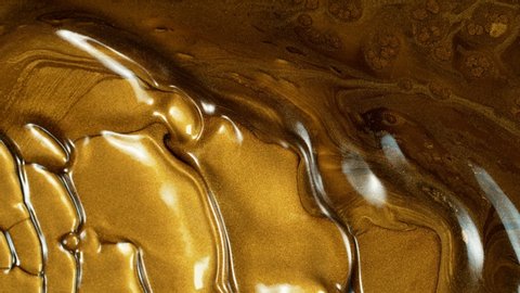 Super Slow Motion Shot of Gold Metallic Background at 1000fps.