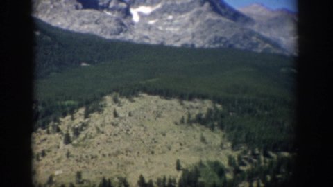 COLORADO USA-1959: Landscape Of Rock Mountains With A Little Snow With Green Trees At The Base