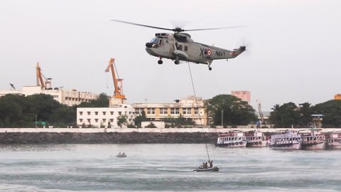 Indian Navy Westland Sea King Helicopter air dropping Marcos commandos for Indian Navy Day 2019 aerial display event rehearsal at Gateway of India, Mumbai.
