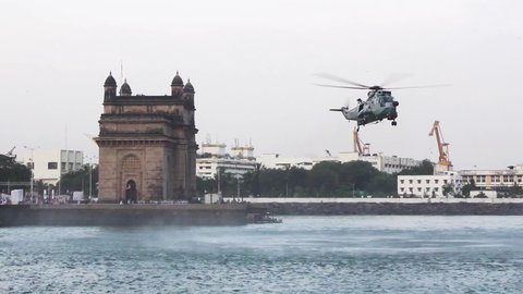 Indian Navy Westland Sea King Helicopter hovering in front of for Gateway of India, Mumbai during Indian Navy Day 2019 aerial display event rehearsal. 