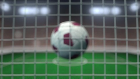Football with flags of Qatar in net against blurred stadium. Conceptual 3D animation