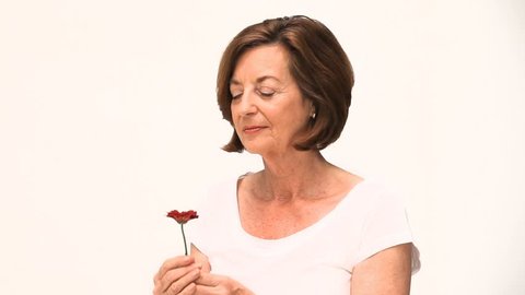 A woman smelling a flower