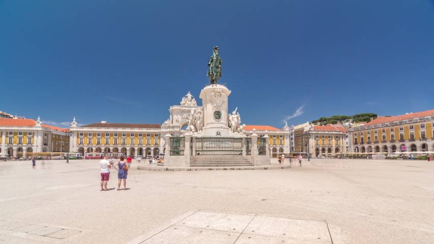 Commerce Square (Praca do Comercio) timelapse hyperlapse in Lisbon, Portugal. Terreiro do Paco, has a statue of of King Jose I in foreground with the arch linking the square with Augusta Street in the Royalty-Free Stock Footage #1042767940