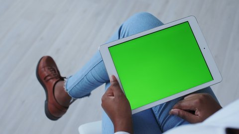 Greenscreen or Chroma Key Tracking. African American Girl with Mobile Tablet PC. Browse Photo Gallery of Internet Shop, Makes Purchases Online. Zooming, Swiping, Tapping or Click keys. Gesturing.