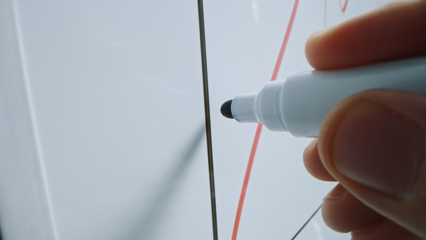 Macro Follow Shot of a Blue Marker Pen Being Held with a Hand. Person Drawing Graphs on a Whiteboard. Pencil is Connected to the Camera. Gripped Shot. Sketching with Fineliner. | Shutterstock HD Video #1042774597