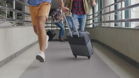 Concept of travel. Female and male tourists running. Traveling people in casual wear with luggage hurry, late for plane or registration. Tourists loosing their flight in despair