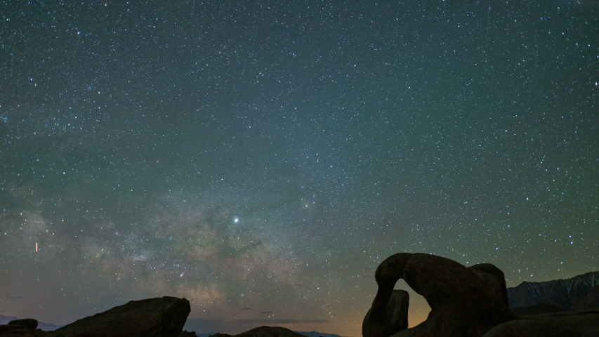 Astro timelapse of Milky Way galaxy over Mobius Arch in Alabama Hills in Sierra Nevada Mountains, California 