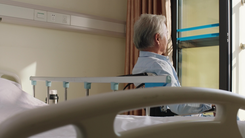 asian old man sitting in wheel chair in his room in nursing home looking happy and content Royalty-Free Stock Footage #1042813024