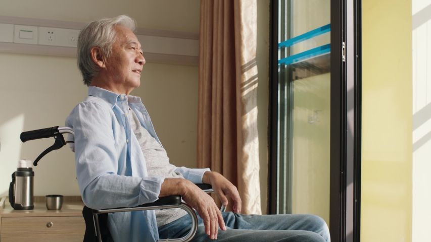 Asian old man sitting in wheel chair in his room in nursing home looking happy and content | Shutterstock HD Video #1042813024