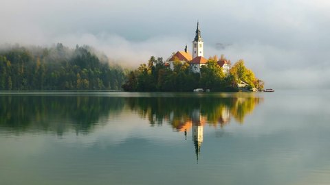 Famous Bled Lake in Triglav National Park in the Julian Alps  in autumn colors at sunrise in Slovenia,Europe. 4K video 