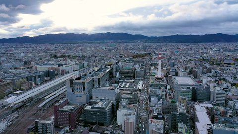 Aerial view 4k video by drone of Kyoto tower and buildings with skyline view in Kyoto city, Japan. evening
