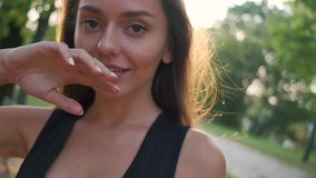 portrait of a beautiful brunette.the girl smiles.girl on nature.slow motion video