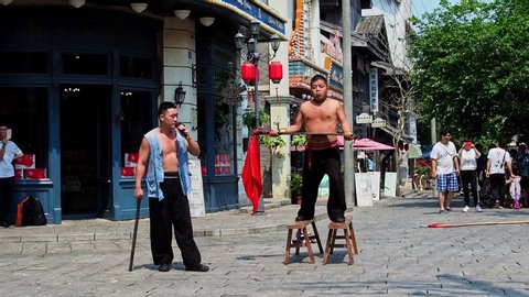 HAINAN, CHINA – MAR 3 2019 - Chinese martial arts / Kung fu performance busking at Feng Xiaogang movie town theme park 